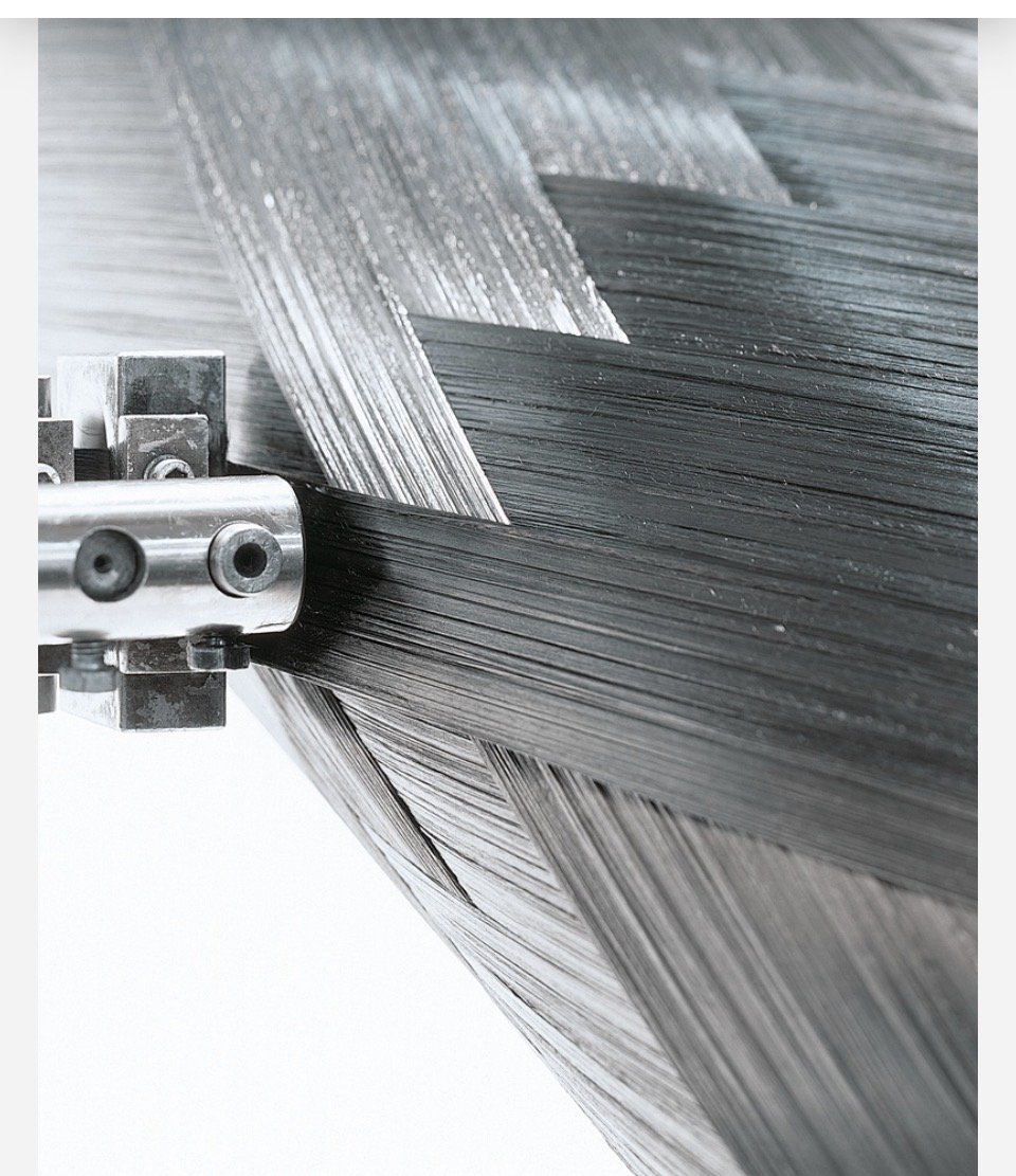 Spread carbon fiber tow feeding into a placement head